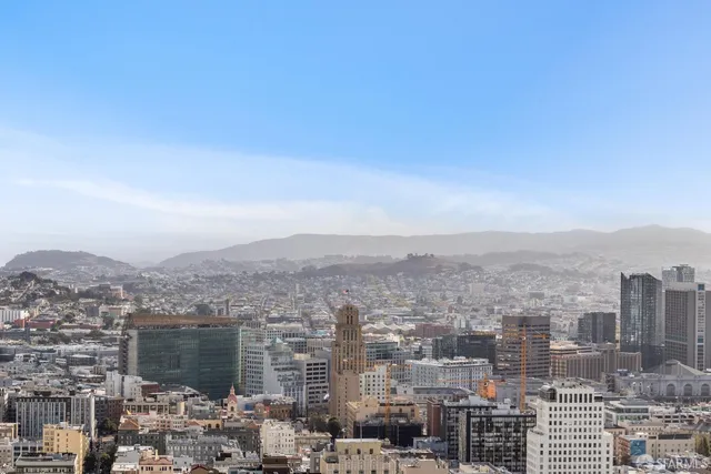 a living room with furniture a window and a chandelier