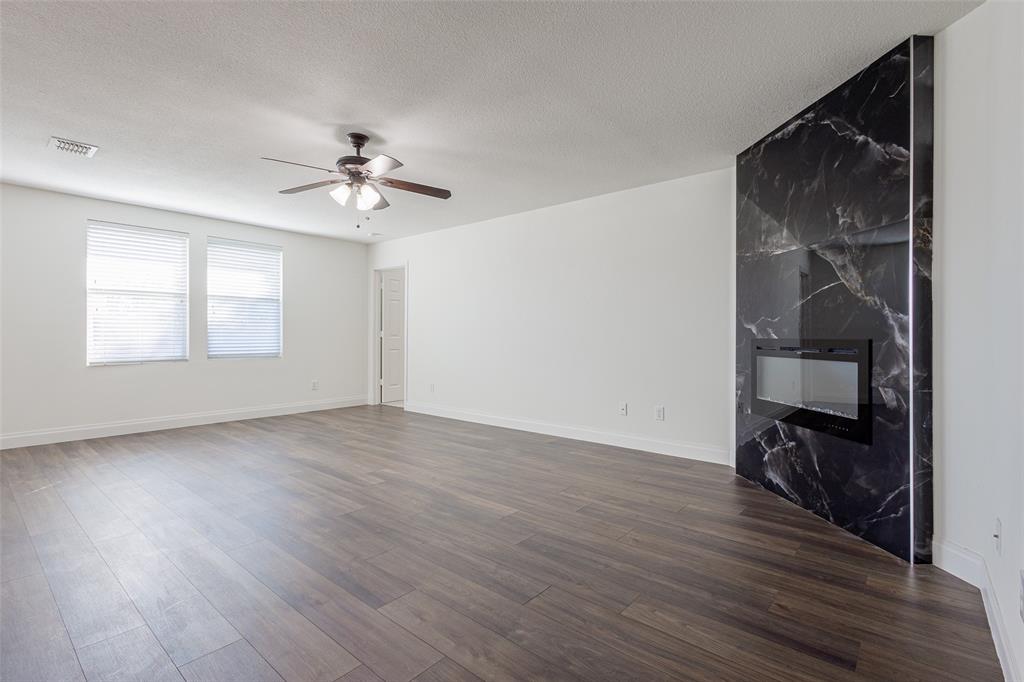 3901 Kathryn Way McKinney, TX 75070 - Photo 11 of 26 a view of empty room with wooden floor and fan