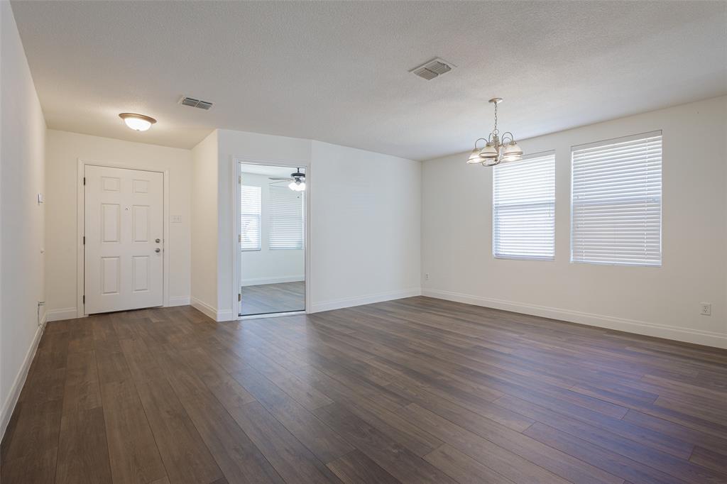 3901 Kathryn Way McKinney, TX 75070 - Photo 12 of 26 an empty room with wooden floor and windows