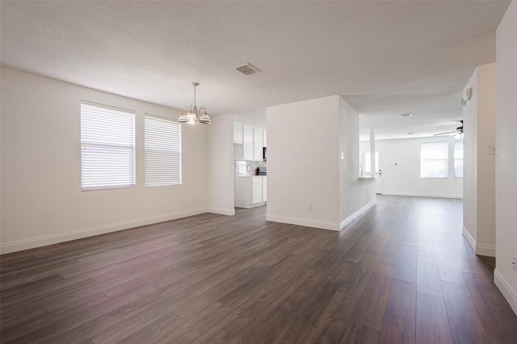 3901 Kathryn Way McKinney, TX 75070 - Photo 13 of 26 an empty room with wooden floor and windows