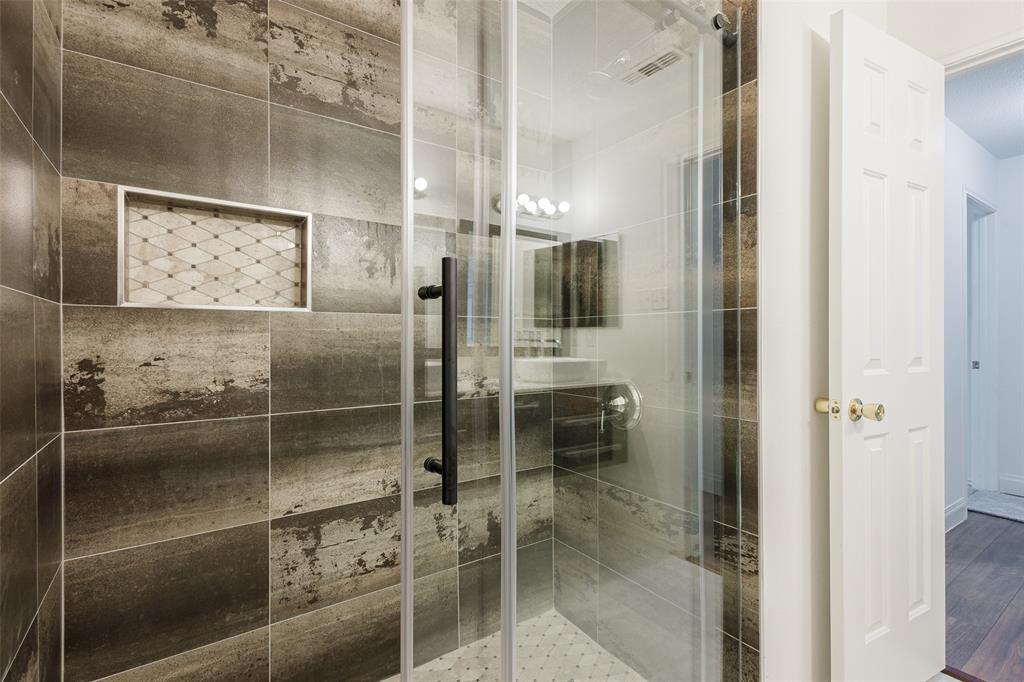 3901 Kathryn Way McKinney, TX 75070 - Photo 17 of 26 a bathroom with a glass shower door