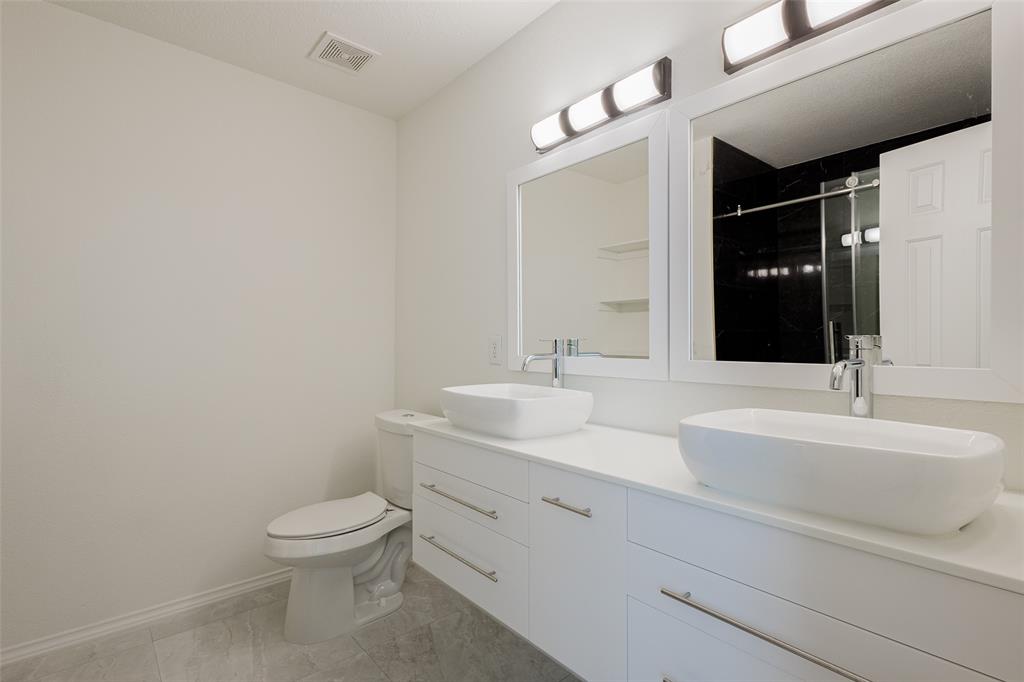 3901 Kathryn Way McKinney, TX 75070 - Photo 21 of 26 a bathroom with a toilet sink and mirror