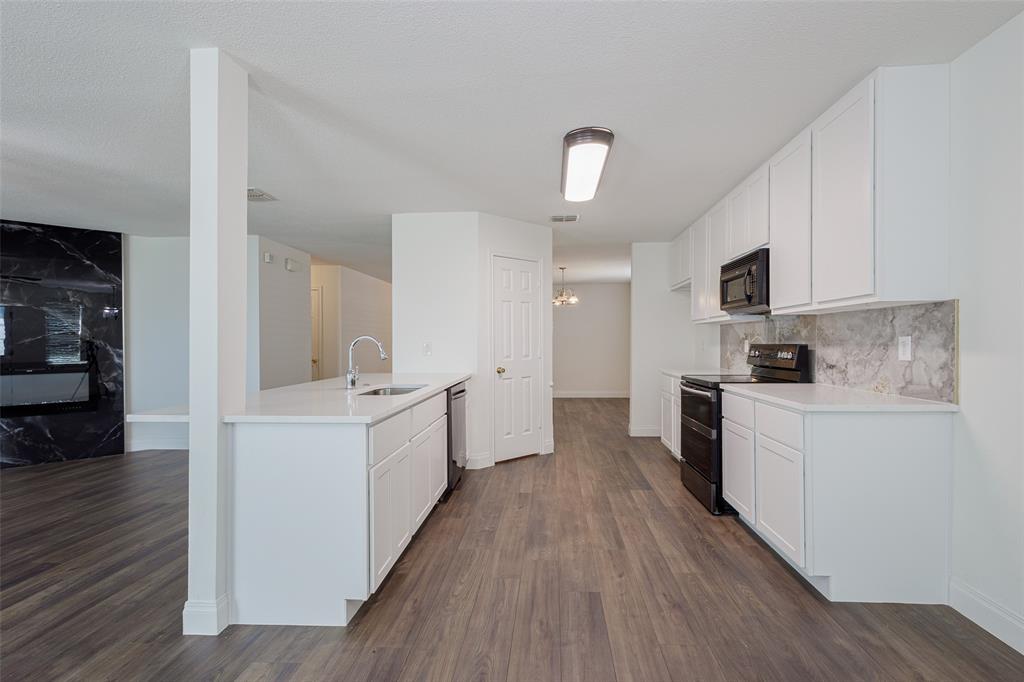 3901 Kathryn Way McKinney, TX 75070 - Photo 4 of 26 a large kitchen with a lot of counter space and wooden floor