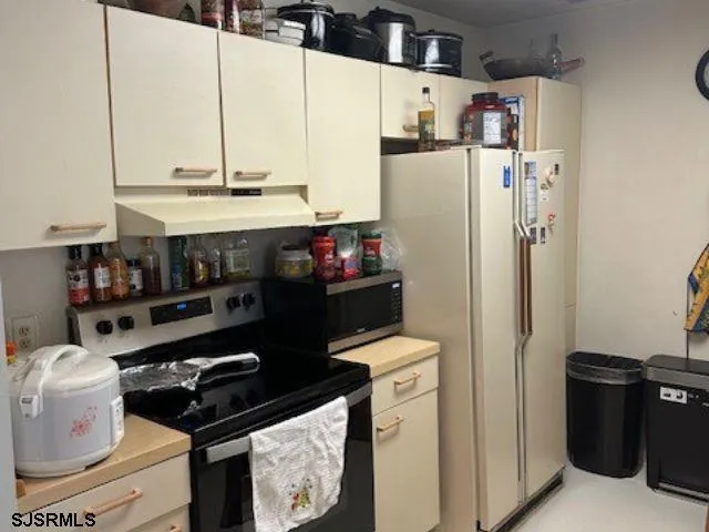 a kitchen with stainless steel appliances a refrigerator and a stove