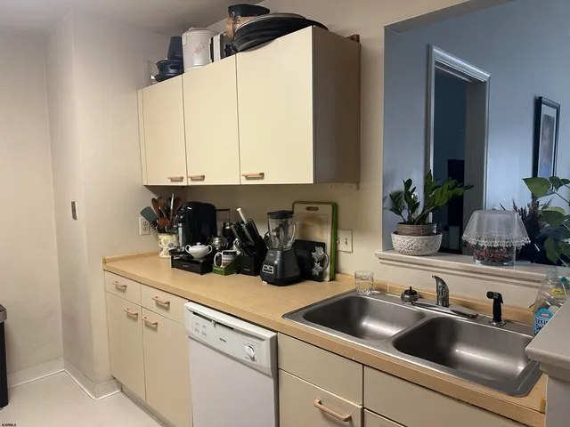 a kitchen with a sink and white cabinets