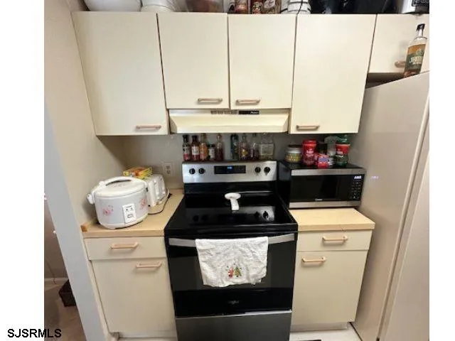 a kitchen with a stove and a microwave