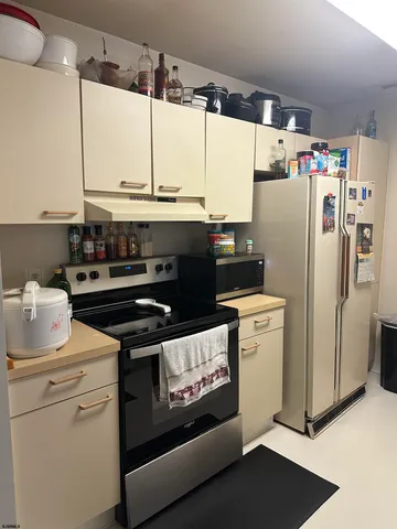 a kitchen with a stove and a refrigerator