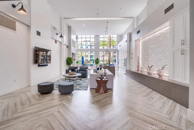a living room with fireplace furniture and a large window