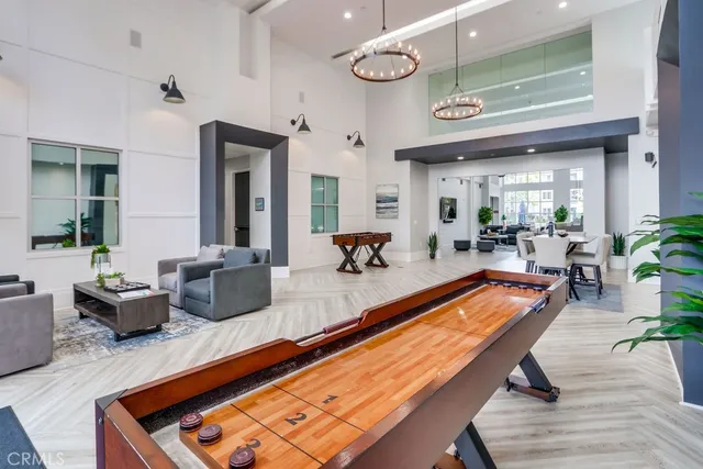 a living room with furniture pool table and a large window