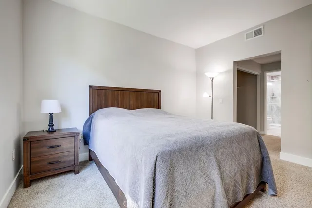 a bedroom with a bed and a lamp