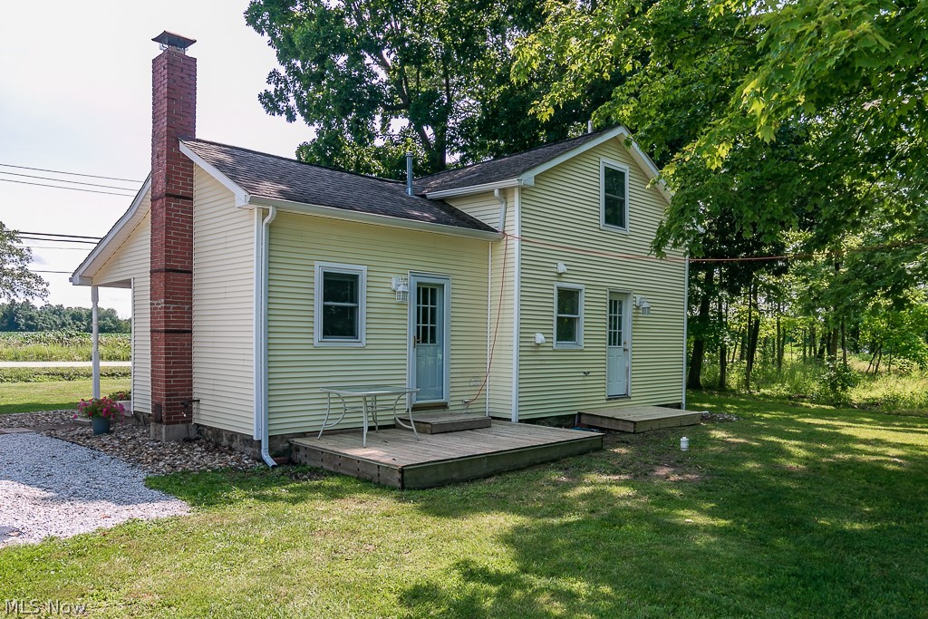16506 Leroy Thompson Road Thompson, OH 44086 - Photo 9 of 41 Back of house featuring a lawn and a wooden deck