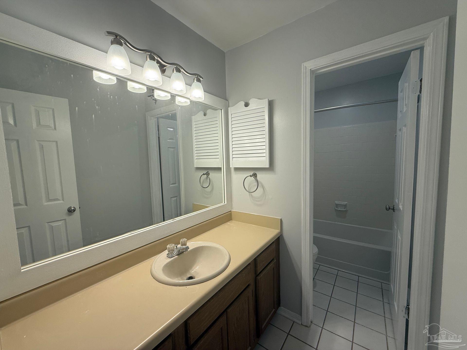 2715 Summertree Lane Gulf Breeze, FL 32563 - Photo 11 of 25 a bathroom with a sink and a mirror