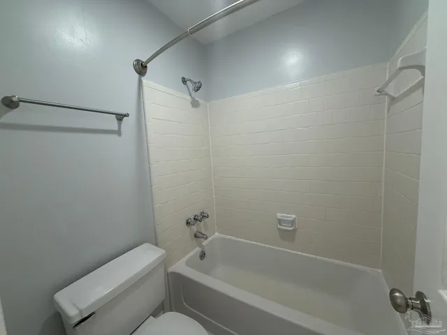 a bathroom with a toilet and a bathtub