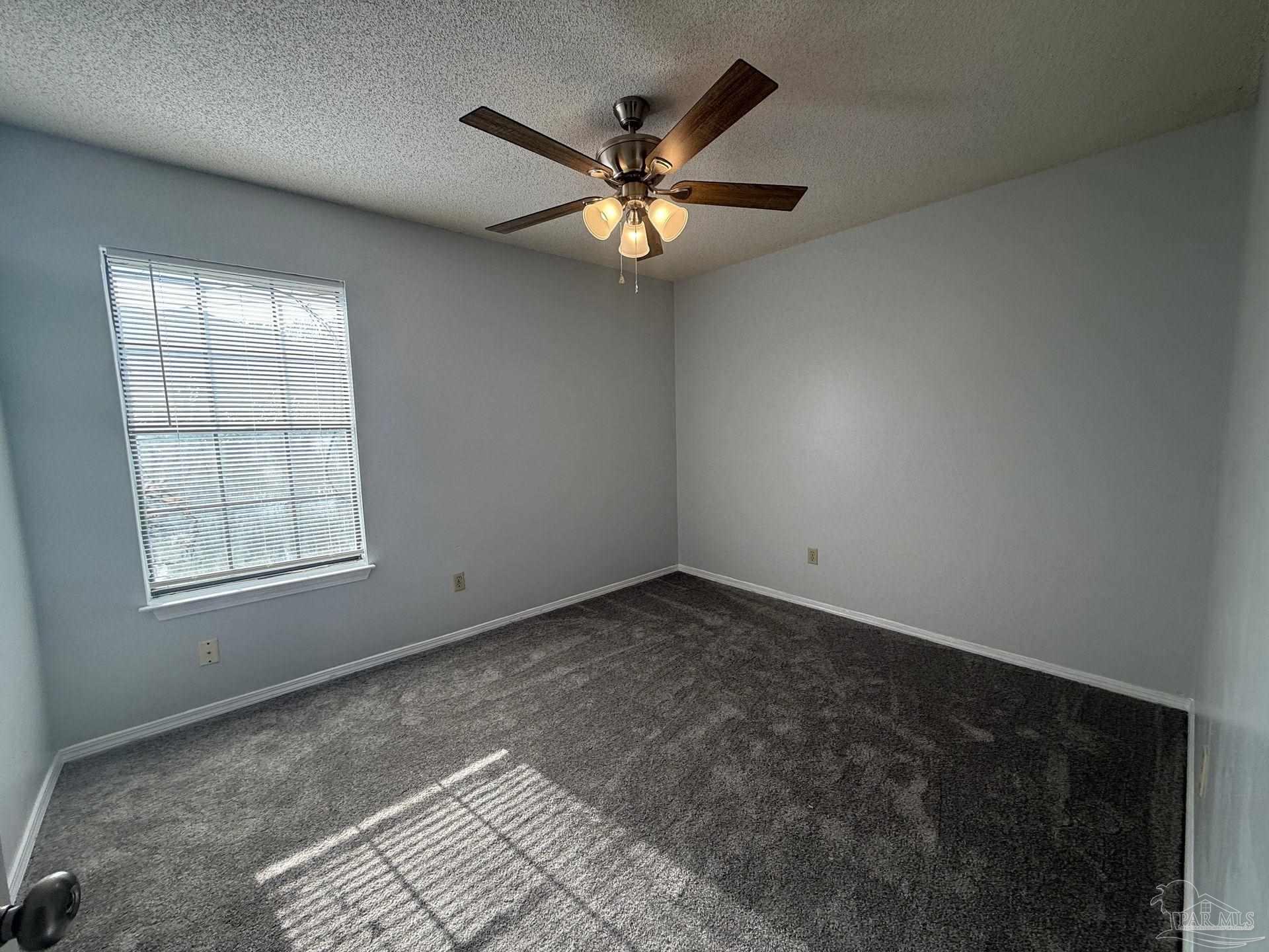 2715 Summertree Lane Gulf Breeze, FL 32563 - Photo 13 of 25 an empty room with window and ceiling fan