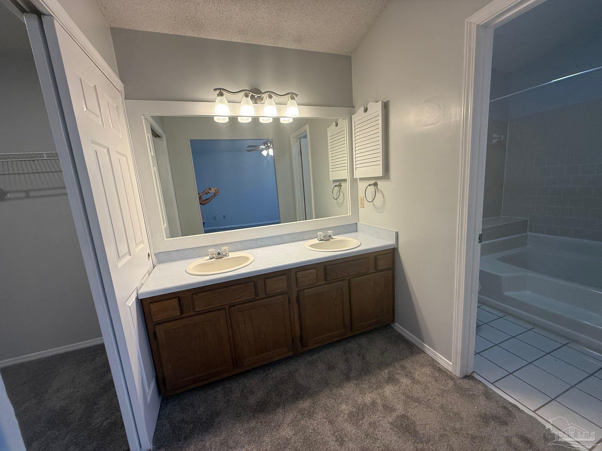2715 Summertree Lane Gulf Breeze, FL 32563 - Photo 20 of 25 a bathroom with a double vanity sink and a mirror