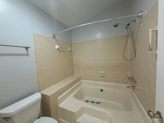 a bathroom with a bath tub with a shower