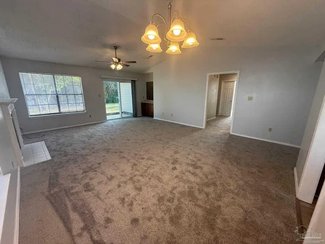 an empty room with windows and entrance