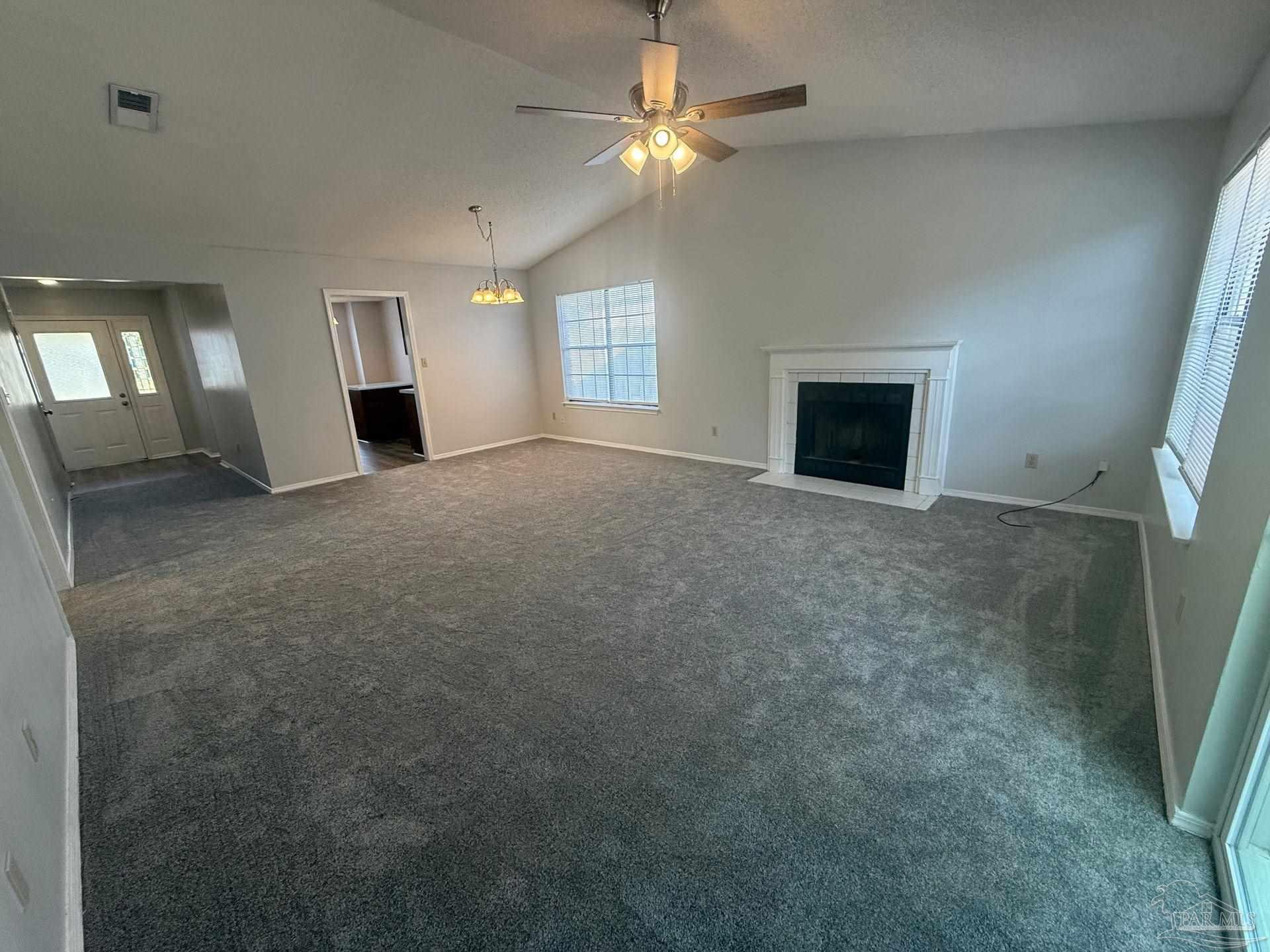 2715 Summertree Lane Gulf Breeze, FL 32563 - Photo 5 of 25 an empty room with windows and fireplace
