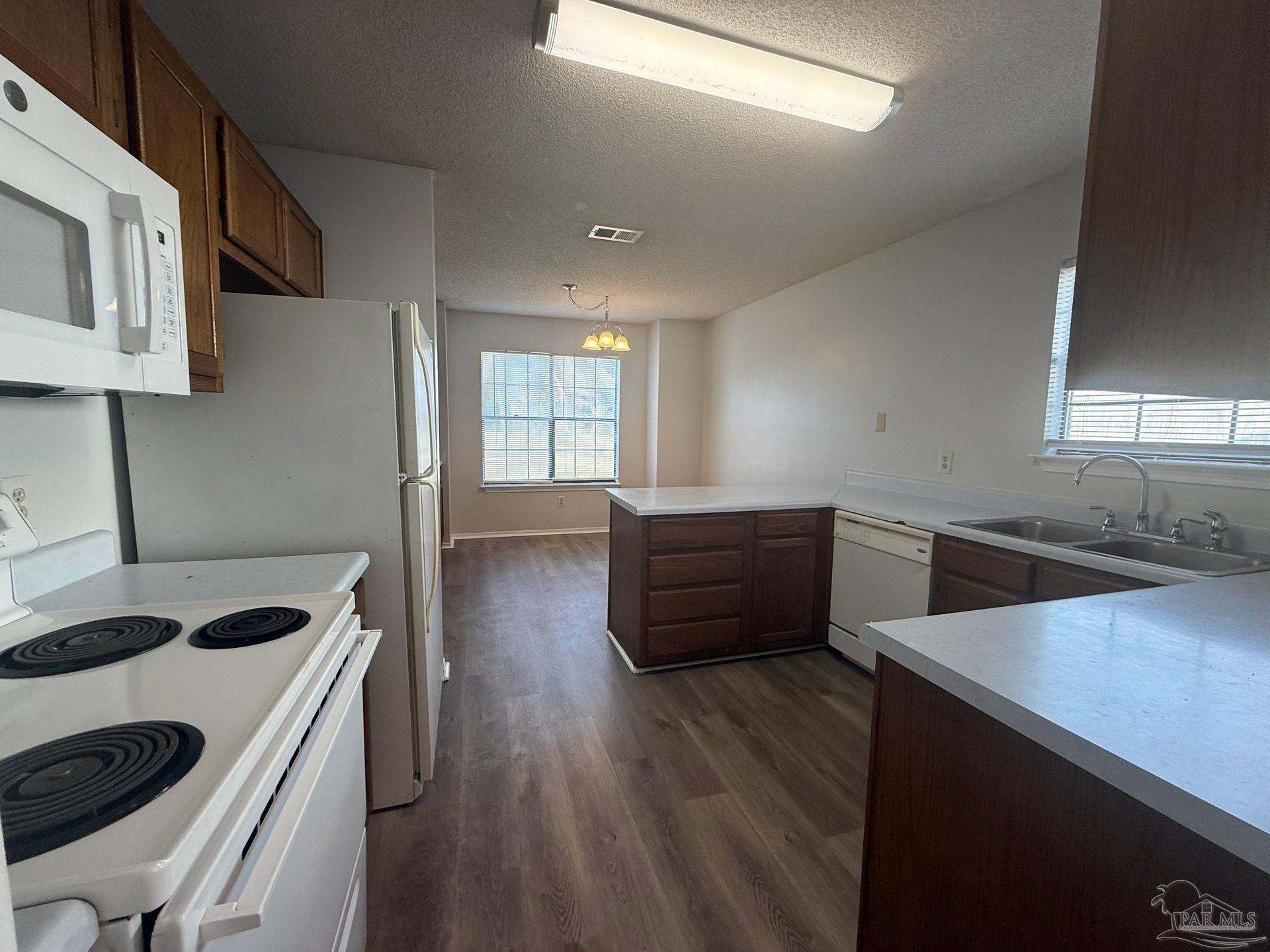 2715 Summertree Lane Gulf Breeze, FL 32563 - Photo 6 of 25 a kitchen with stainless steel appliances sink and wooden floor