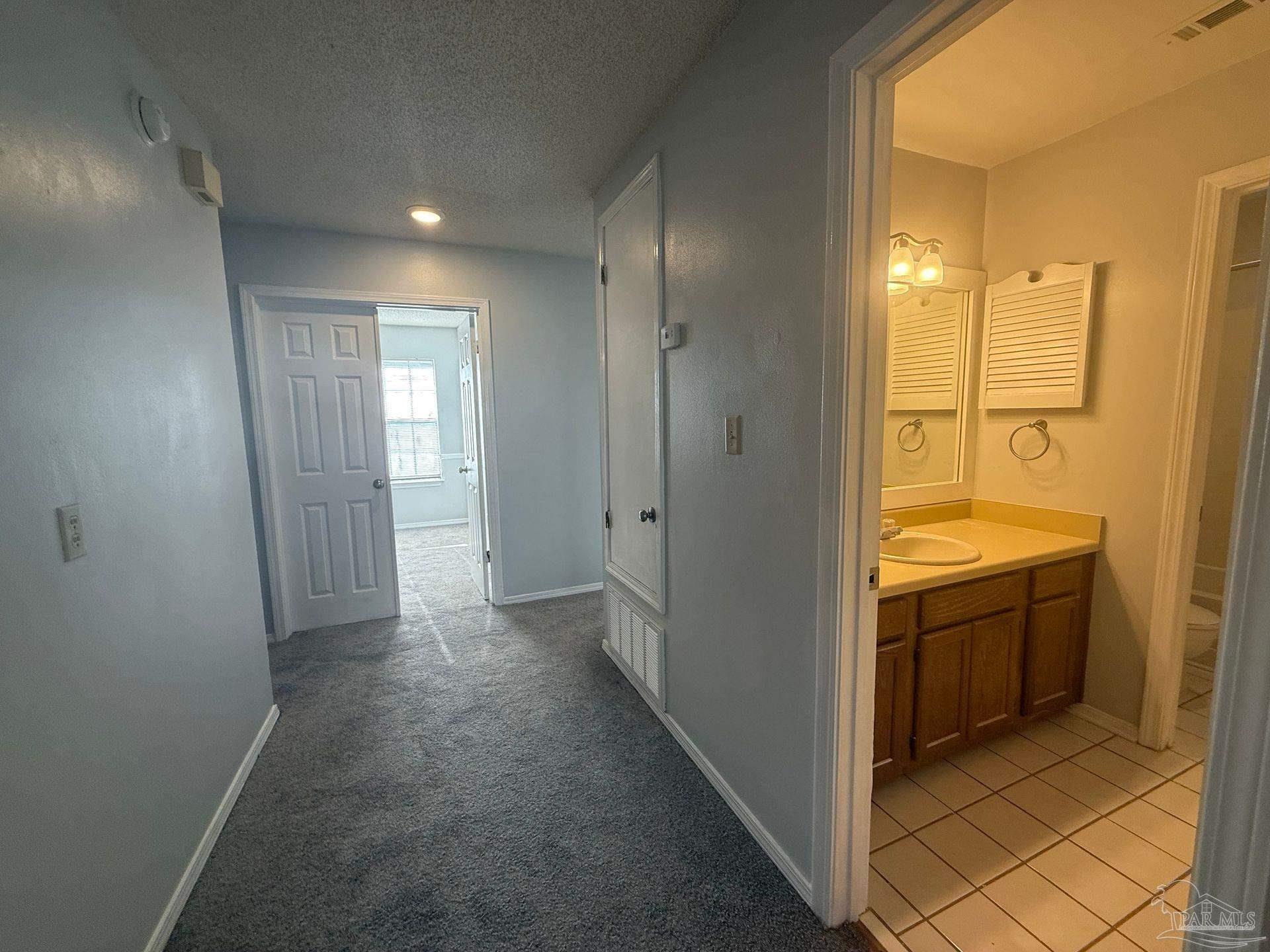 2715 Summertree Lane Gulf Breeze, FL 32563 - Photo 10 of 25 a view of hallway with shower and wooden door