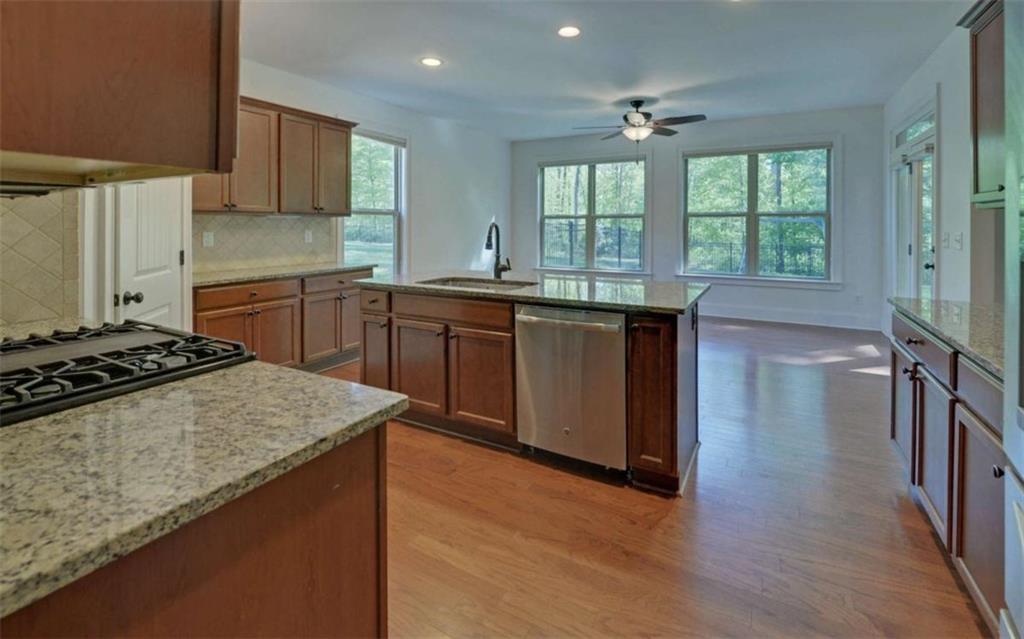 255 Abbington Way Clarkesville, GA 30523 - Photo 11 of 49 a kitchen with stainless steel appliances granite countertop a stove a sink dishwasher and a refrigerator