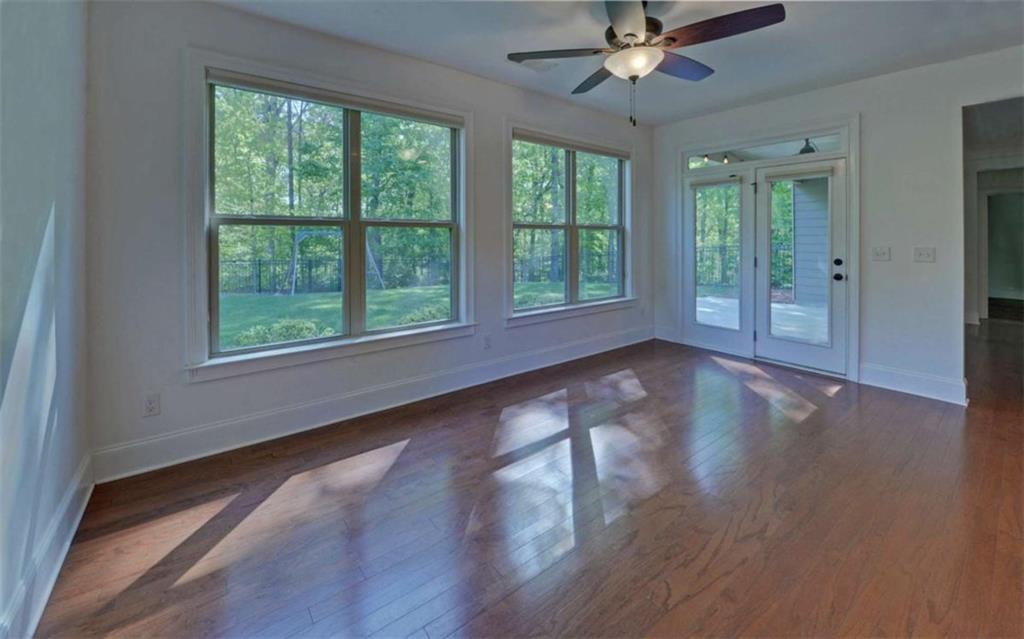 255 Abbington Way Clarkesville, GA 30523 - Photo 12 of 49 a view of an empty room with wooden floor and a window