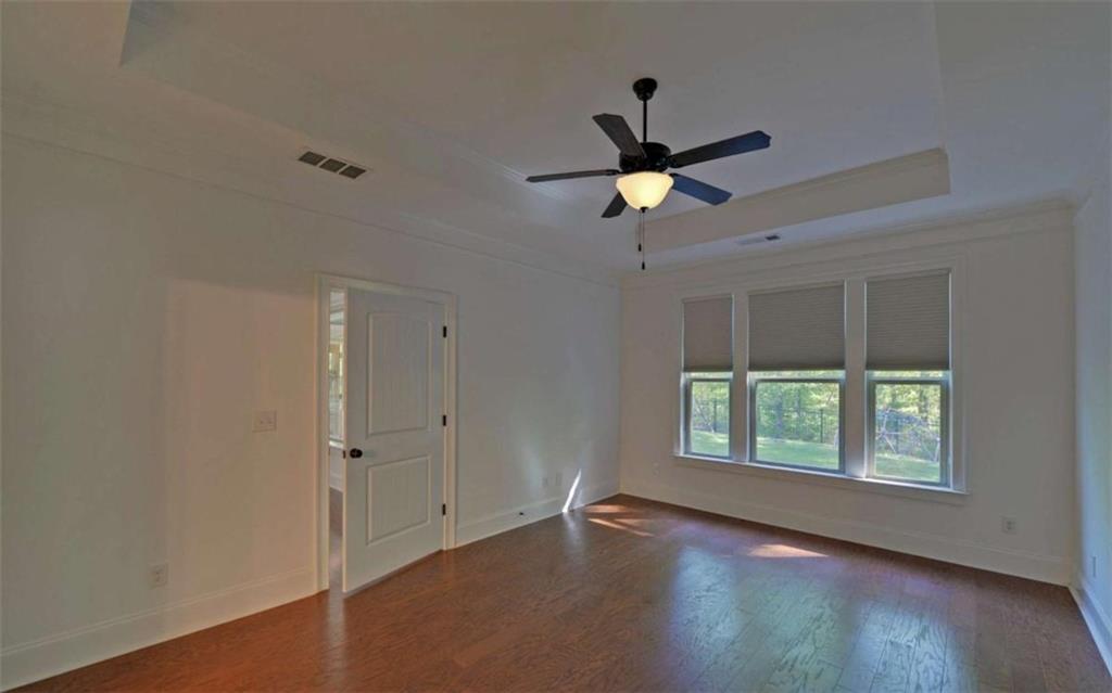 255 Abbington Way Clarkesville, GA 30523 - Photo 21 of 49 wooden floor in an empty room with a window