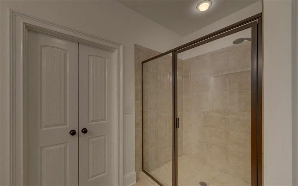 255 Abbington Way Clarkesville, GA 30523 - Photo 25 of 49 a bathroom with a glass shower door