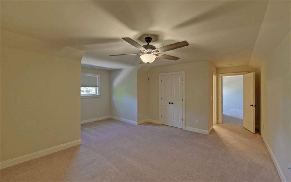 255 Abbington Way Clarkesville, GA 30523 - Photo 29 of 49 an empty room with a ceiling fan and a window