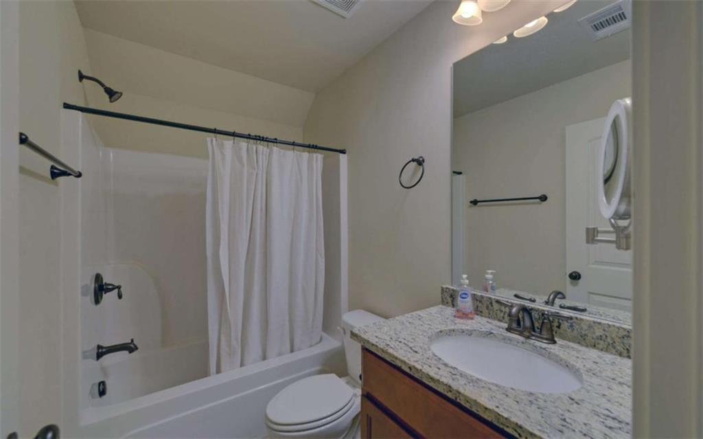 255 Abbington Way Clarkesville, GA 30523 - Photo 34 of 49 a bathroom with a granite countertop sink toilet and shower