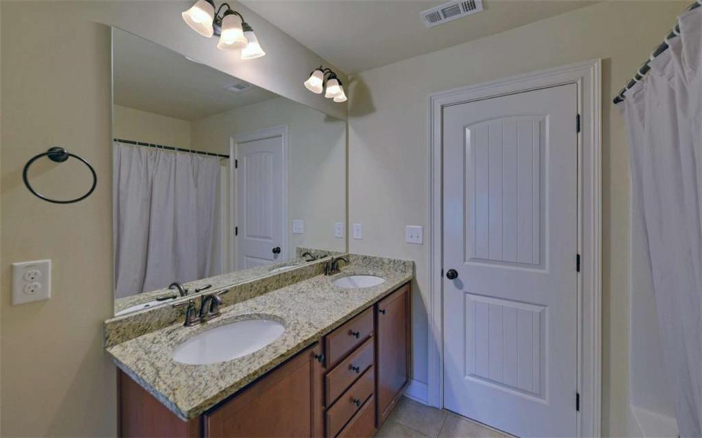255 Abbington Way Clarkesville, GA 30523 - Photo 38 of 49 a bathroom with a granite countertop sink and a mirror