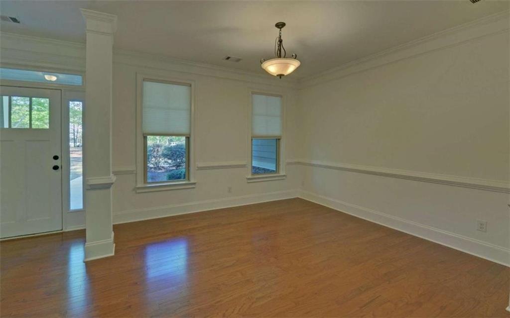 255 Abbington Way Clarkesville, GA 30523 - Photo 4 of 49 an empty room with wooden floor and windows