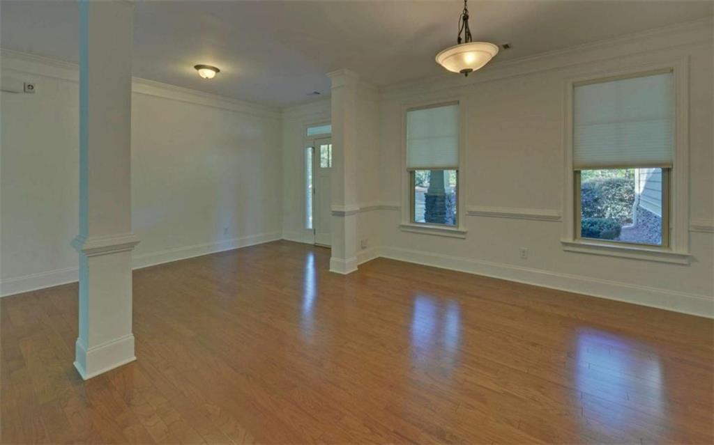 255 Abbington Way Clarkesville, GA 30523 - Photo 5 of 49 an empty room with wooden floor and windows