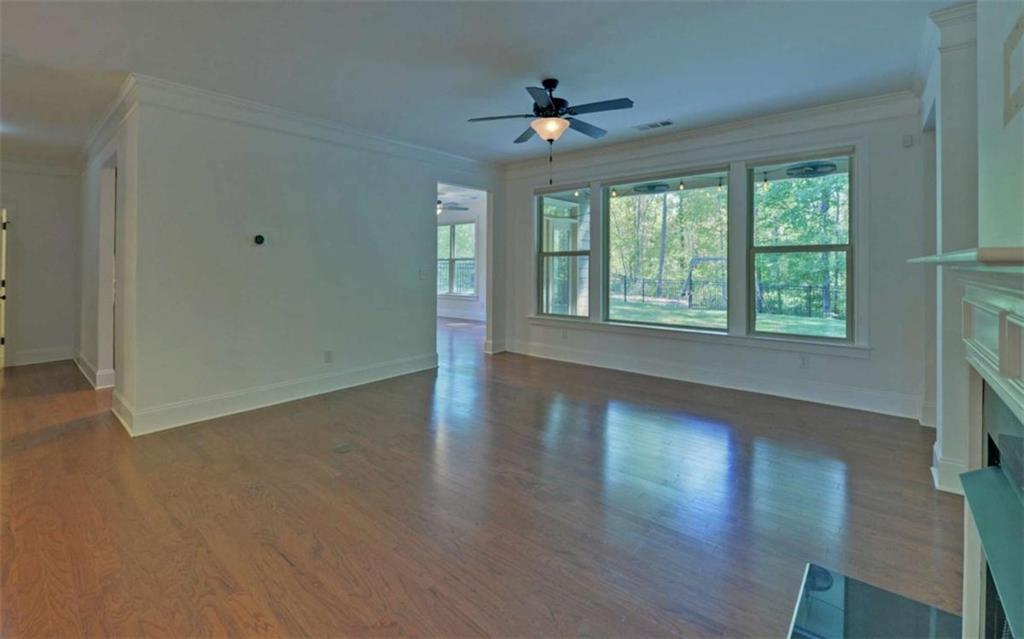 255 Abbington Way Clarkesville, GA 30523 - Photo 6 of 49 a view of an empty room with wooden floor and a window