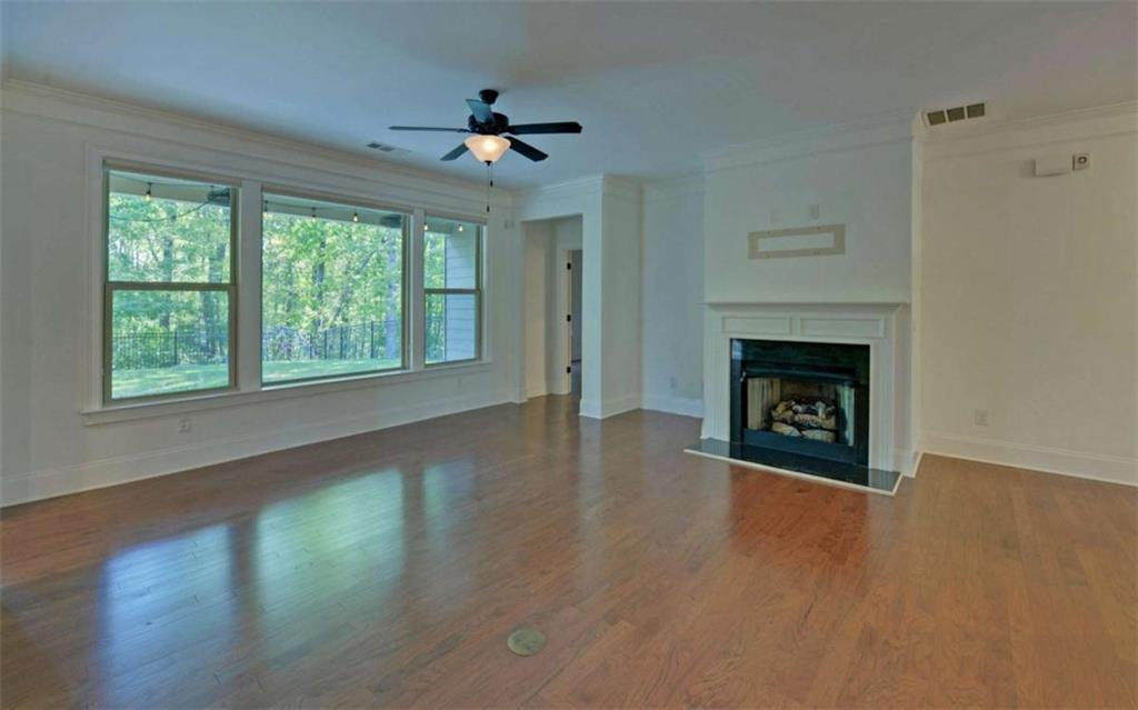 255 Abbington Way Clarkesville, GA 30523 - Photo 7 of 49 a view of an empty room with wooden floor fireplace and a window