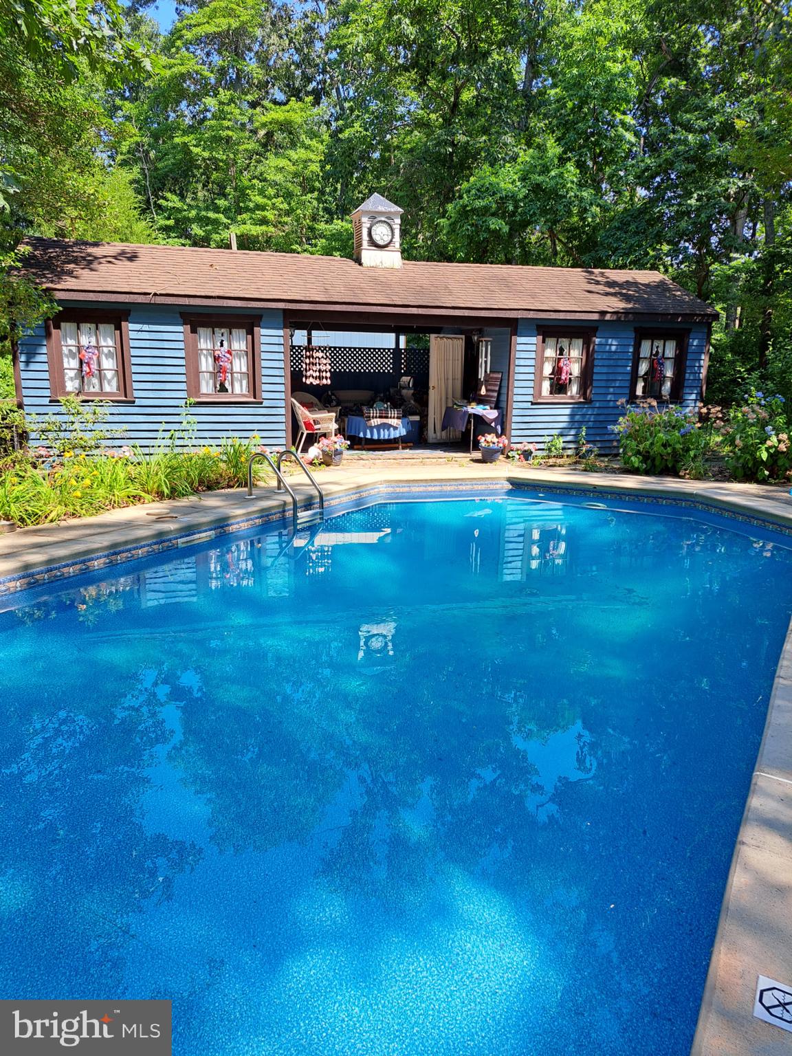 12 Mallard Drive Tabernacle, NJ 08088 - Photo 16 of 31 a view of a swimming pool with lawn chairs and plants