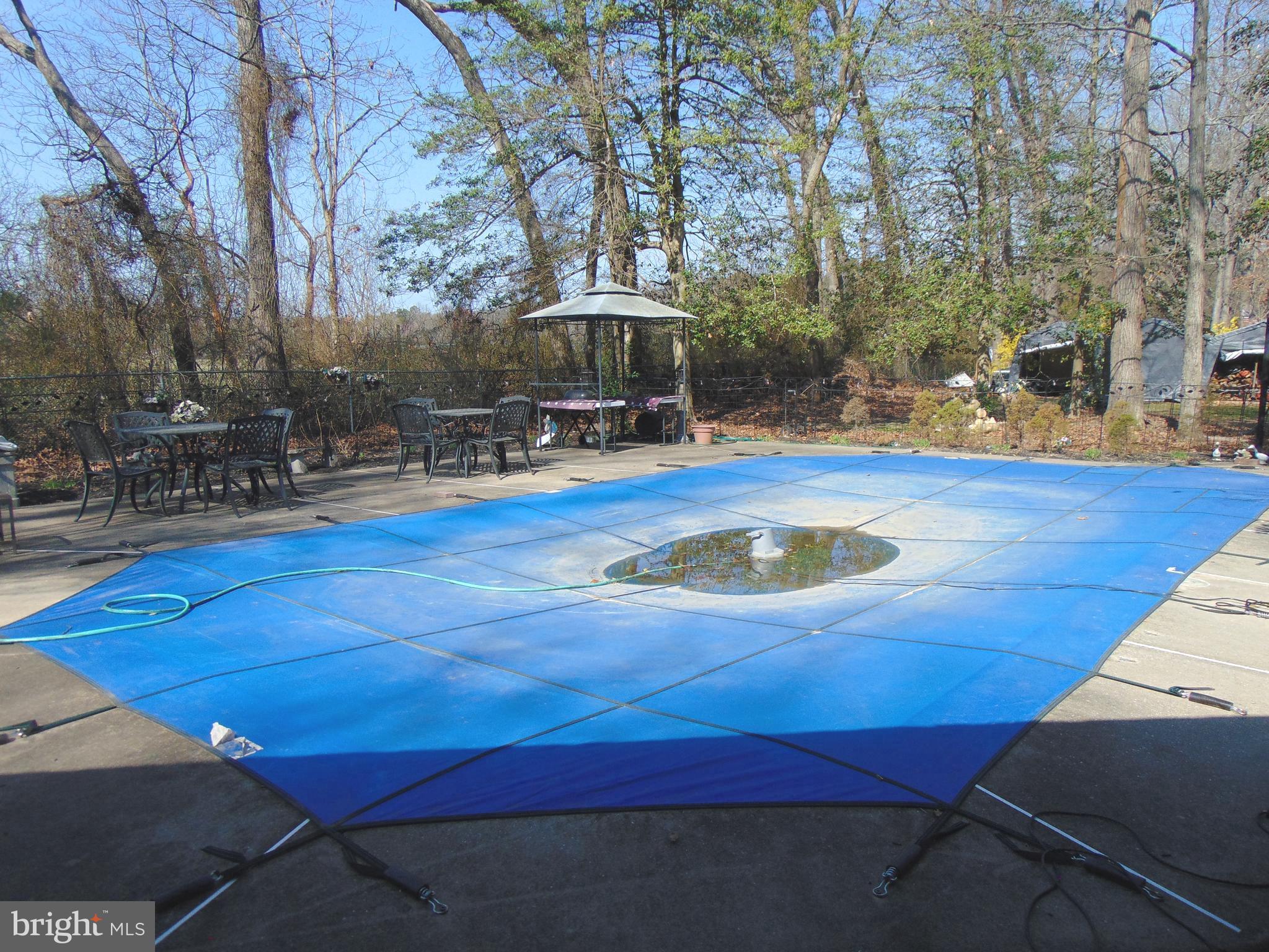 12 Mallard Drive Tabernacle, NJ 08088 - Photo 24 of 31 a view of a swimming pool with lawn chairs under an umbrella