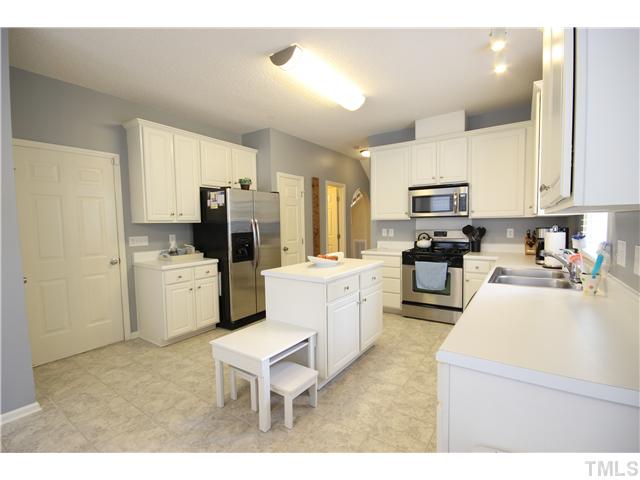 8661 Harps Mill Road Raleigh, NC 27615 - Photo 6 of 25 Large kitchen with island has stainless steel appliances and ceramic tile floors.