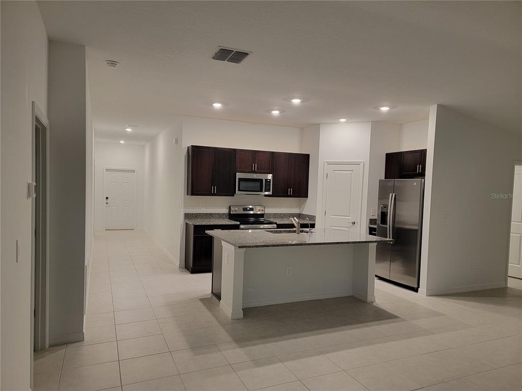 1844 Red Loop Lakeland, FL 33801 - Photo 3 of 24 a kitchen with stainless steel appliances a refrigerator and a stove top oven
