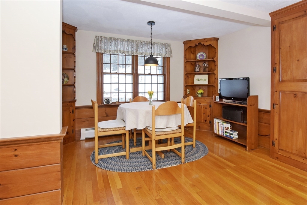 47 Sunrise Road Boxford, MA 01921 - Photo 11 of 42 a dining room with a furniture and a flat screen tv