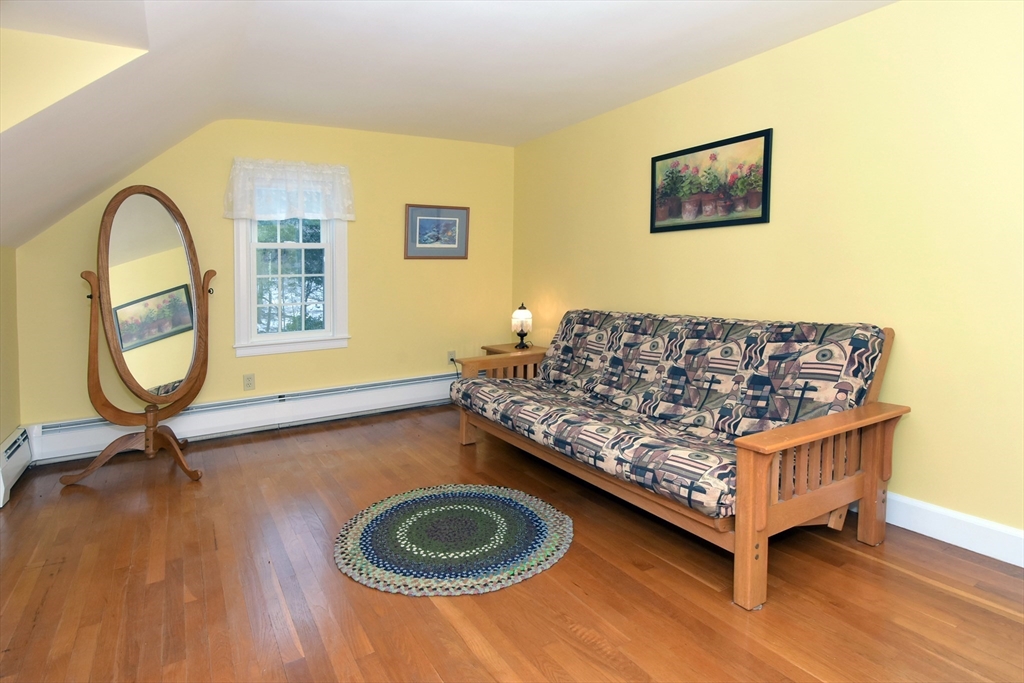 47 Sunrise Road Boxford, MA 01921 - Photo 35 of 42 a living room with a couch and a table with wooden floor