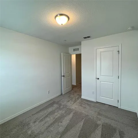 a view of an empty room and a window