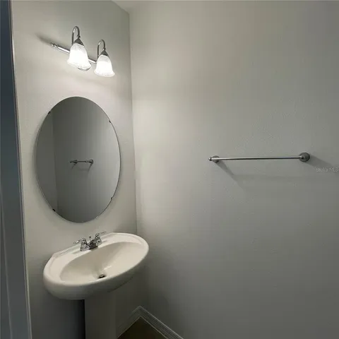 a bathroom with a sink and mirror