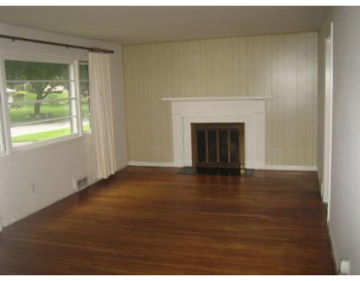 69 Talbot Road Springfield, MA 01119 - Photo 3 of 7 a view of an empty room with wooden floor and a window