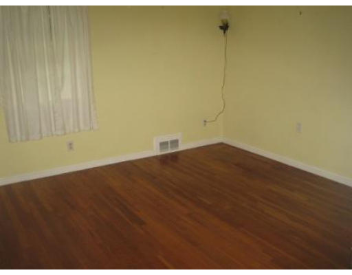 69 Talbot Road Springfield, MA 01119 - Photo 5 of 7 a view of a room with wooden floor and a ceiling fan