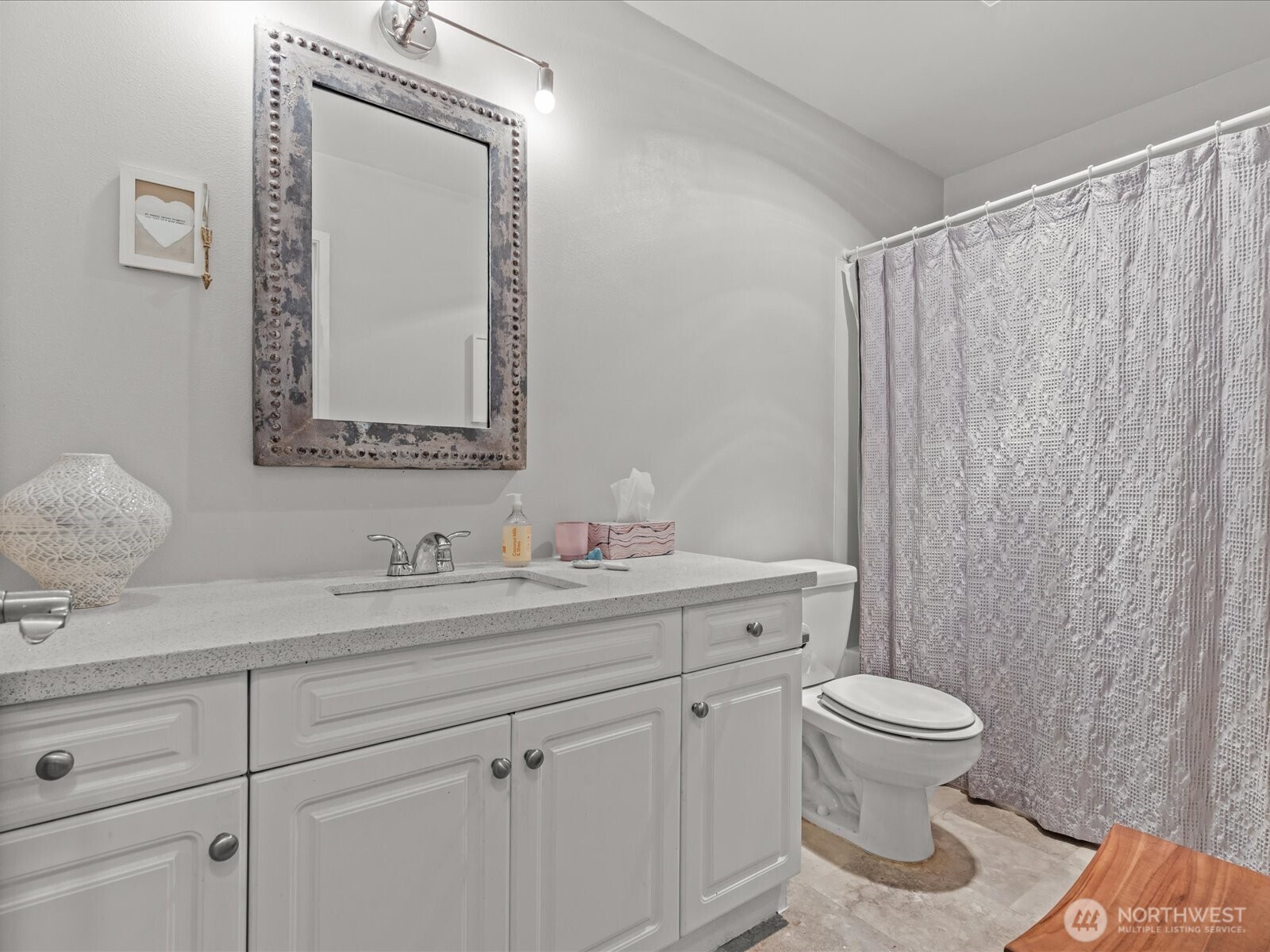 15150 140th Way Southeast, Unit P204 Renton, WA 98058 - Photo 11 of 28 a bathroom with a toilet sink a mirror and vanity