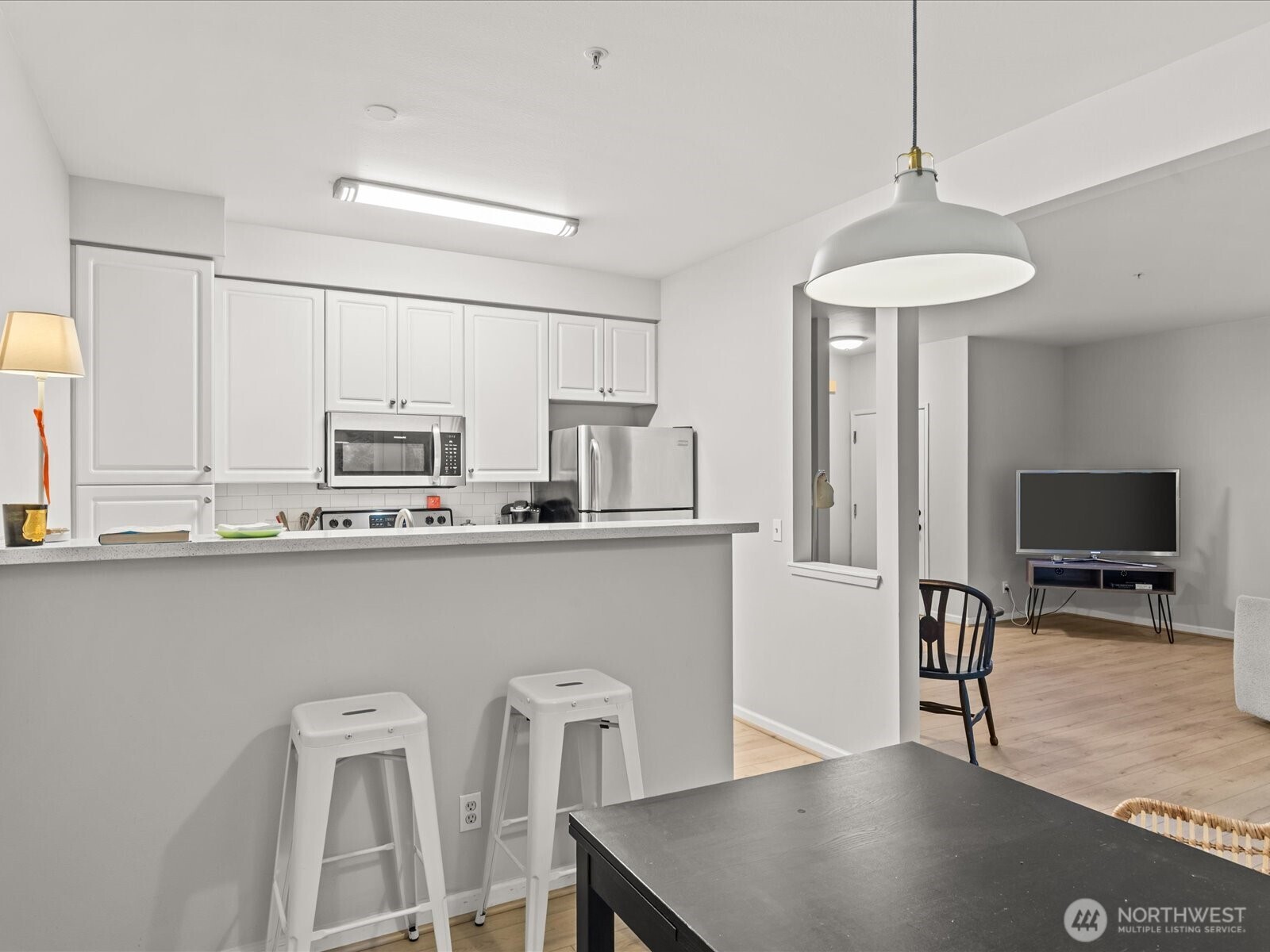 15150 140th Way Southeast, Unit P204 Renton, WA 98058 - Photo 17 of 28 a kitchen with stainless steel appliances a table and chairs in it