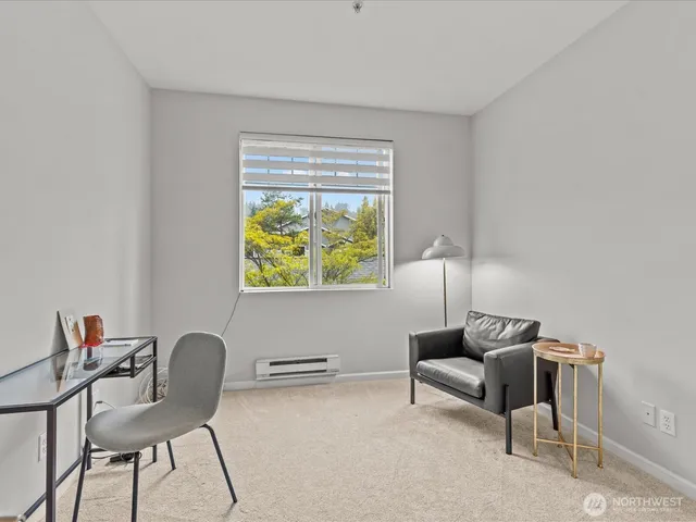 a bedroom with a bed and a wall painting