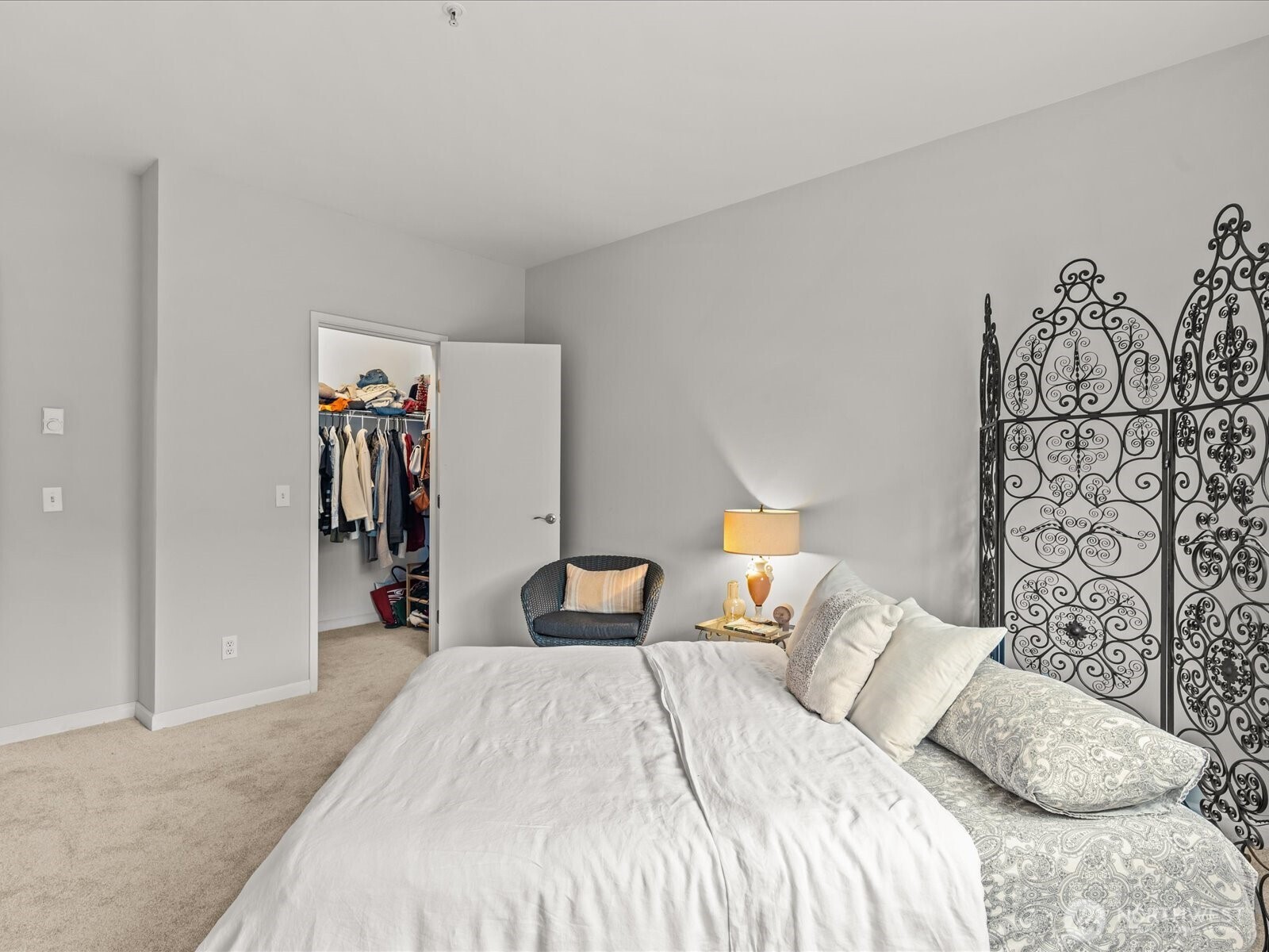 15150 140th Way Southeast, Unit P204 Renton, WA 98058 - Photo 21 of 28 a bedroom with a bed and a wall painting