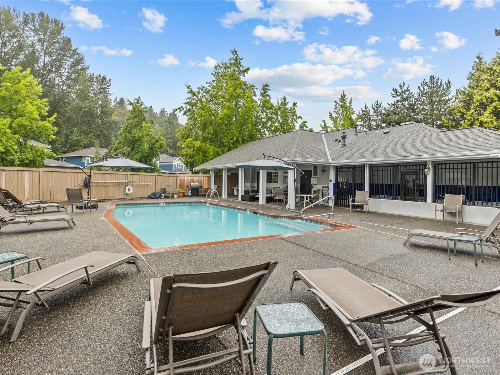15150 140th Way Southeast, Unit P204 Renton, WA 98058 - Photo 25 of 28 a view of house with swimming pool outdoor seating and covered with trees